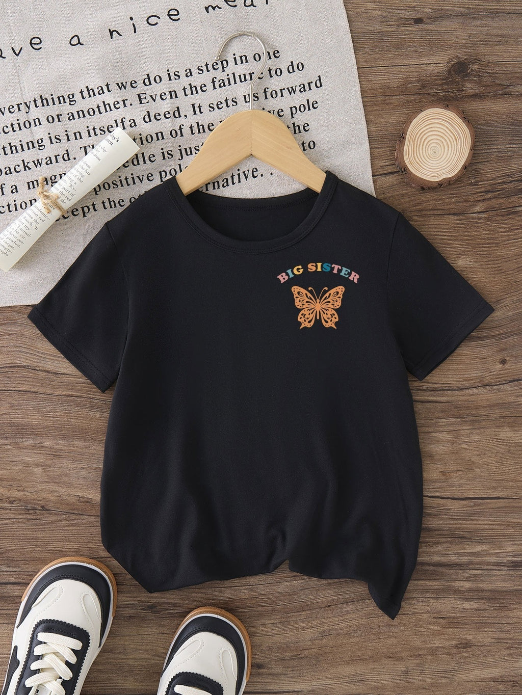 Girls' In My Big Sister Era T-Shirt in Black with a Butterfly Chest Print and Colorful Back Lettering
